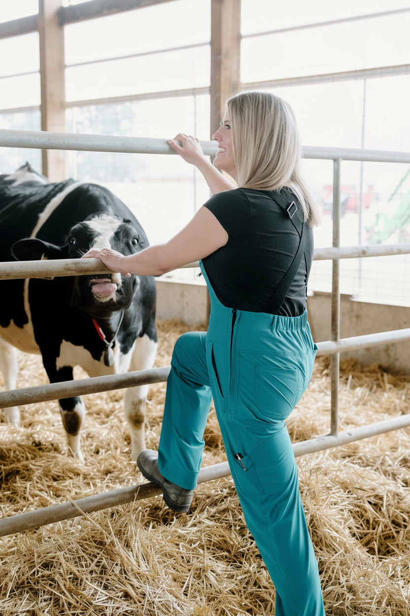 Woman interacting with a cow inside a barn